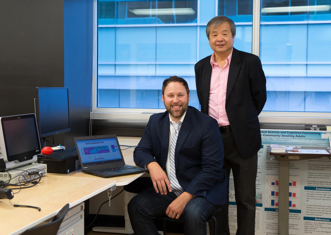 Cumming School of Medicine researchers discover a way to diagnose subtypes of fear of falling, a common condition experienced by people who have Parkinson’s disease. The findings indicate the current standard of treatment for fear of falling may not be effective for all patients. From left: Taylor Chomiak and Bin Hu.