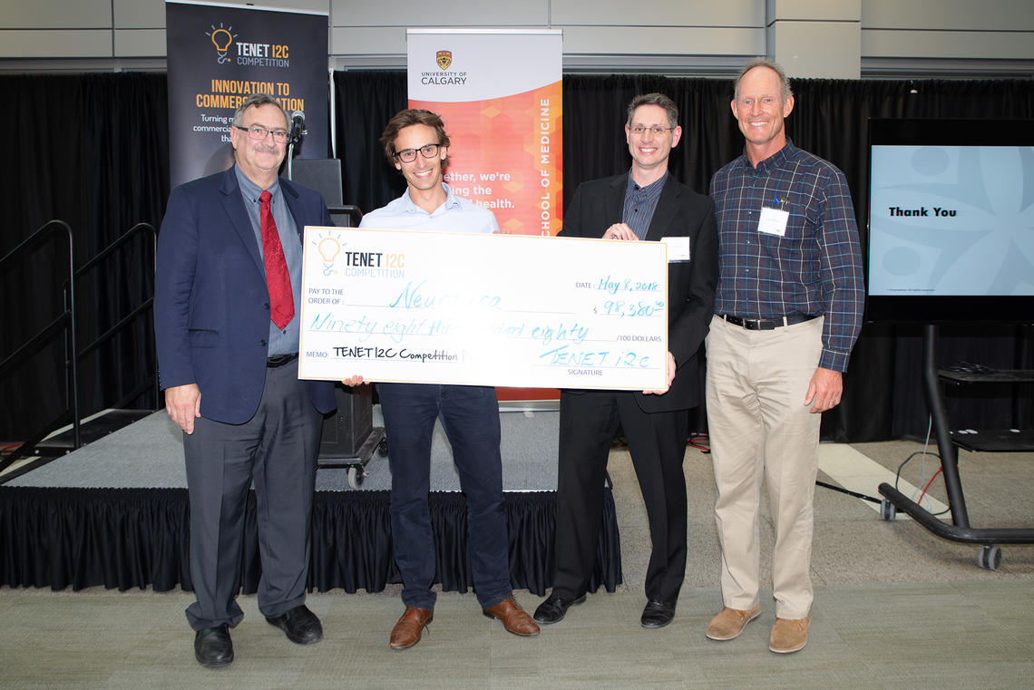First-place team Neuraura was presented with the prize cheque at the 2018 TENET i2c competition finals on May 8. From left: Jon Meddings, dean of the Cumming School of Medicine; Pierre Wijdenes and Colin Dalton of Neuraura; and competition founder Ken Moore.