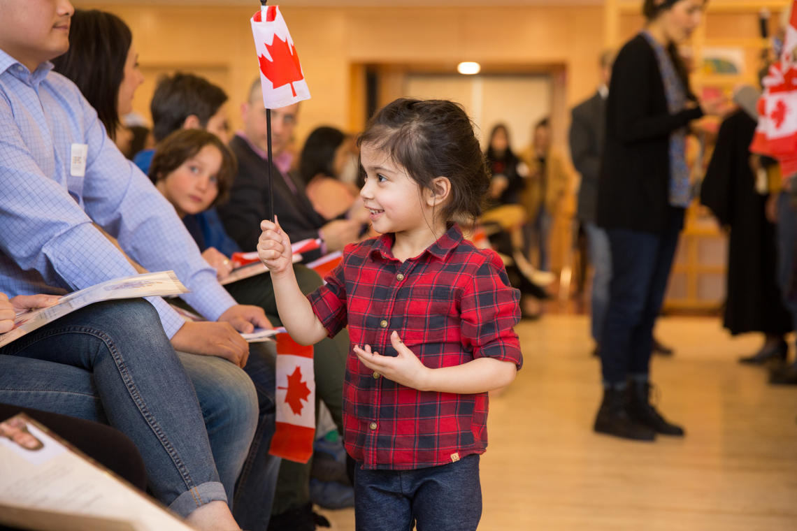 Families and friends gather to welcome 47 new Canadian citizens at University of Calgary ceremony on March 13.