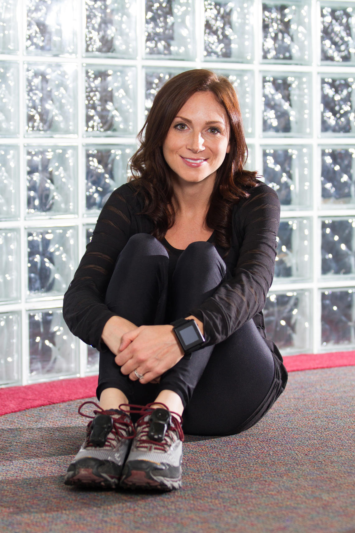 Dr. Breanne Everett, MD’09, MBA’13, wears a pair of running shoes fitted with one of the Orpyx sensor platforms