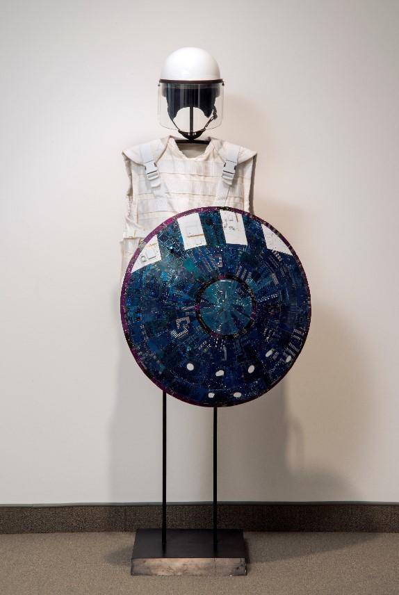 Wally Dion (Canadian, born 1976), Armour Set, 2008, Computer circuit boards, enamel paint, wood, fabric, steel plates, composite riot helmet, various materials, 182.9 x 889 x 50.8, Collection of the MacKenzie Art Gallery, gift of an anonymous donor, 2017-18.