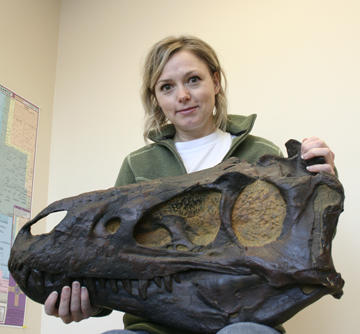 Darla Zelenitsky holds a cast of a tyrannosaurid skull.