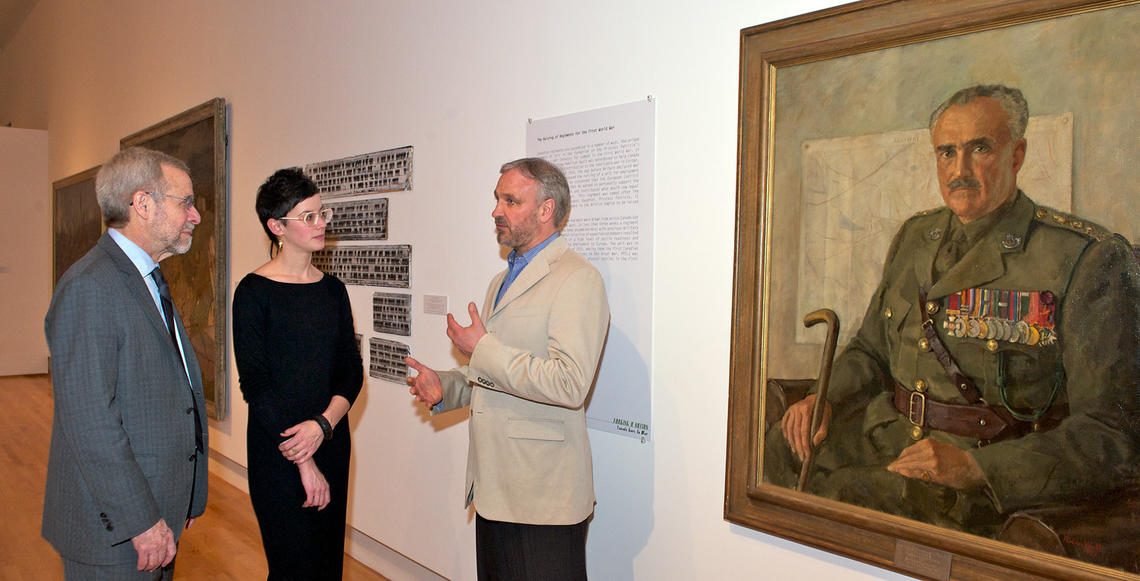 From left: Tom Hickerson, vice-provost; Lindsey Sharman, curator of art, The Founders' Gallery; and Alex Gault next to a portrait of his great grand-uncle, PPCLI founder Hamilton Gault.
