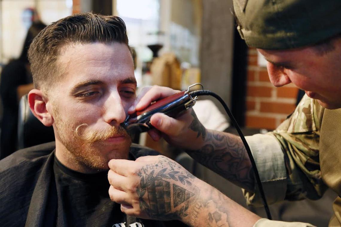 Barber Ryan Rich, right, shaves Adam Paul’s moustache at Movember & Co. in 2014 in Culver City, Calif.