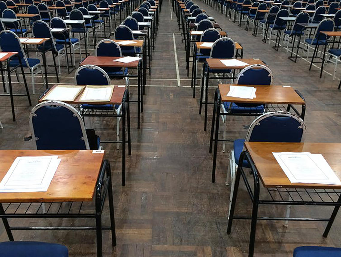 desks with exam papers