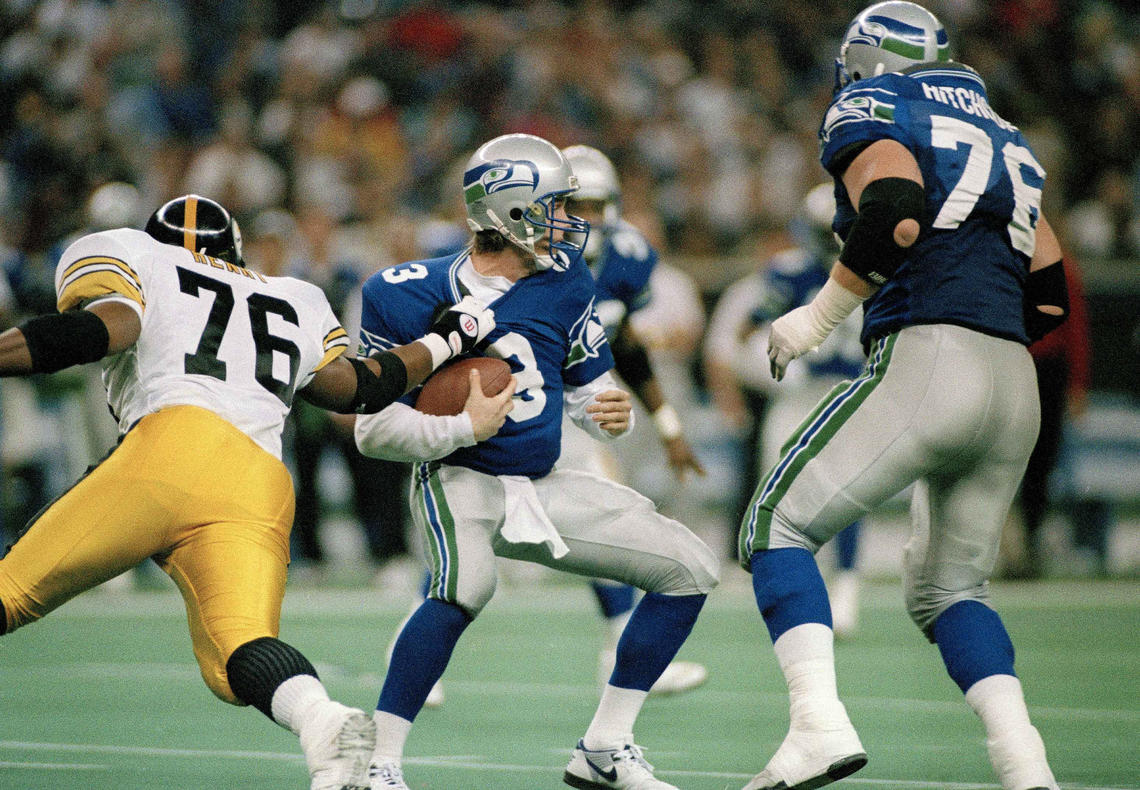 Seattle Seahawks quarterback Rick Mirer (3) is sacked for a seven-yard-loss by Kevin Henry (76) of the Pittsburgh Steelers during the second quarter of their NFL game on Dec. 26, 1993. 