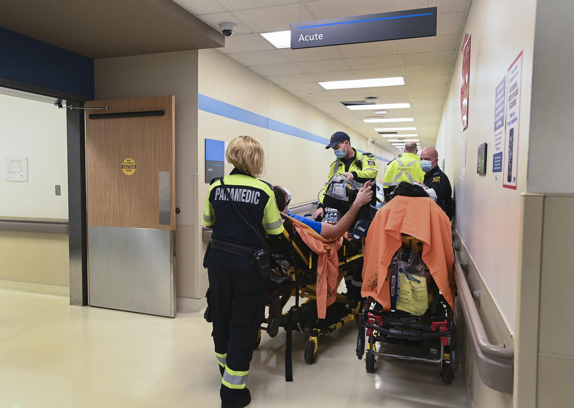 Paramedics deliver patients to the emergency department at the Humber River Hospital in Toronto during the COVID-19 pandemic. 