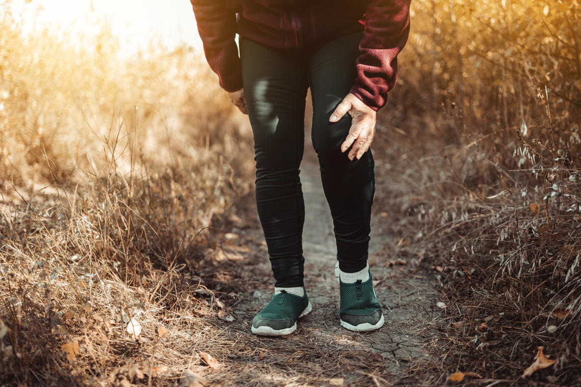Image of a person walking with a sore knee