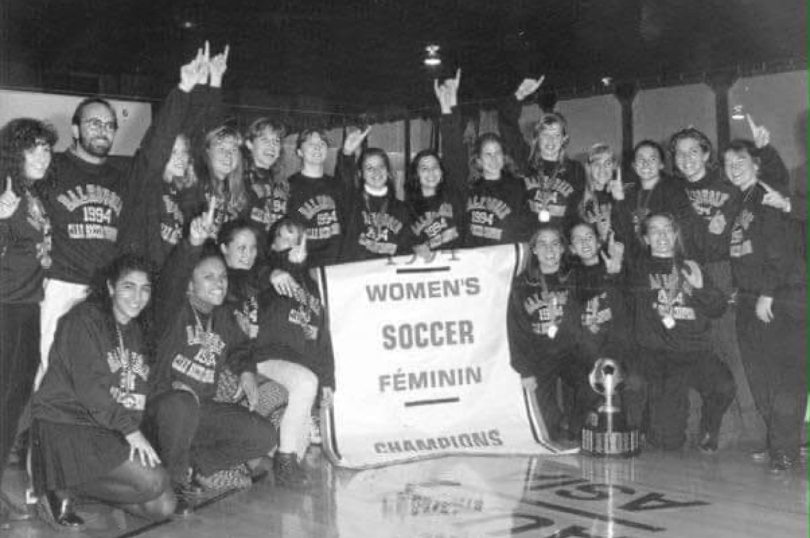Black and white photo of Dalhousie women's soccer team with banner that reads Women's Soccer Feminin Champions