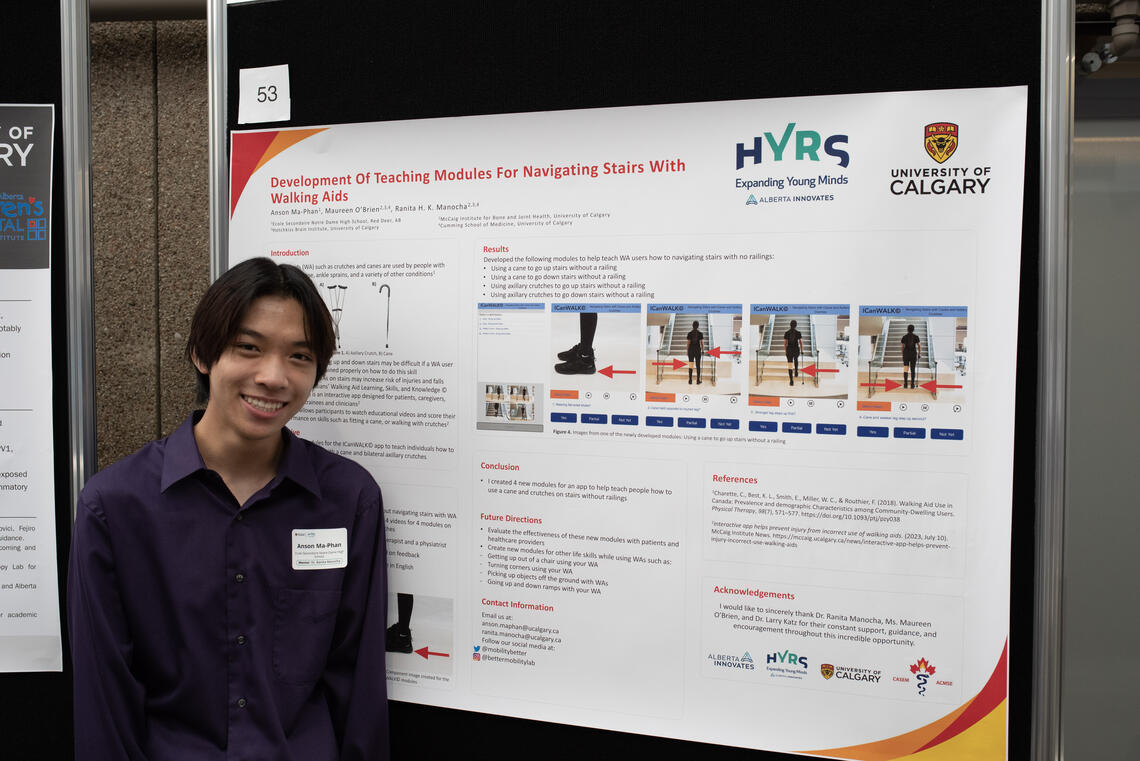 Anson Ma-Phan a 2023 HYRS student stands in front of his poster