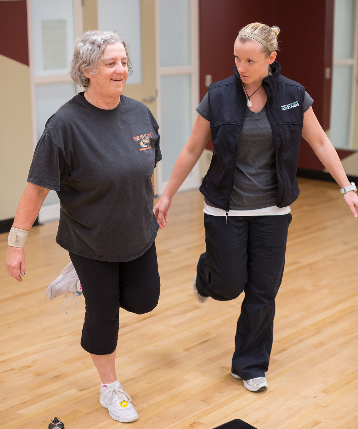 TrymGym/HealthyU participant with trainer during a group fitness class.