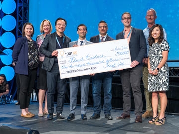Fluid Biotech Inc. team receives 1st place and the prize cheque at the 2019 TENET i2c competition finals. From left: Sandra Stabel, Dr. Brenda Kenny, John H. Wong, Dr. Alim Mitha, Rahim Nathu, and Casey Smit, Elisa Park, and Ken Moore.