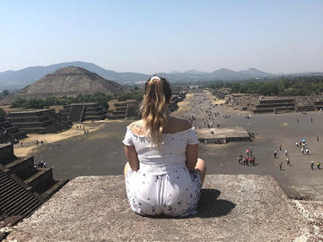 Emily Tetrault sits looking out over Mayan ruins in Teotihuacán, Mexico.