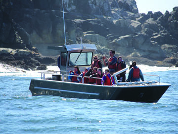 A group of people onboard an uncovered boat