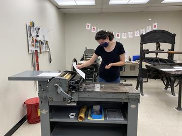 Student Sarah Carlson works on a rare Vandercook SP15 Printing Press