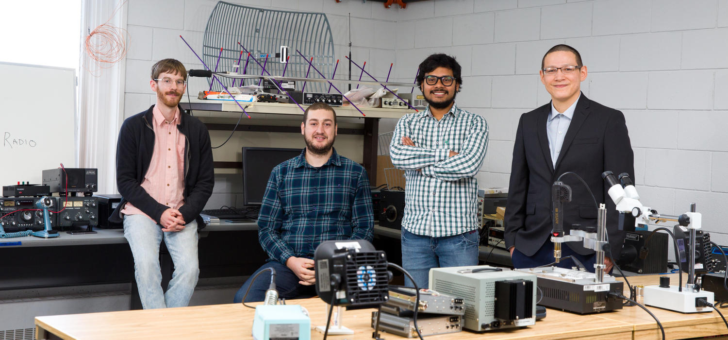 Tushar Sharma, third from left, a graduate student at iRadio Lab in the Department of Electrical and Computer Engineering at the Schulich School of Engineering, poses with fellow engineers. From left: David Garrett, Anis Ben Arfi, Sharma, and Bruce Buffalo.
