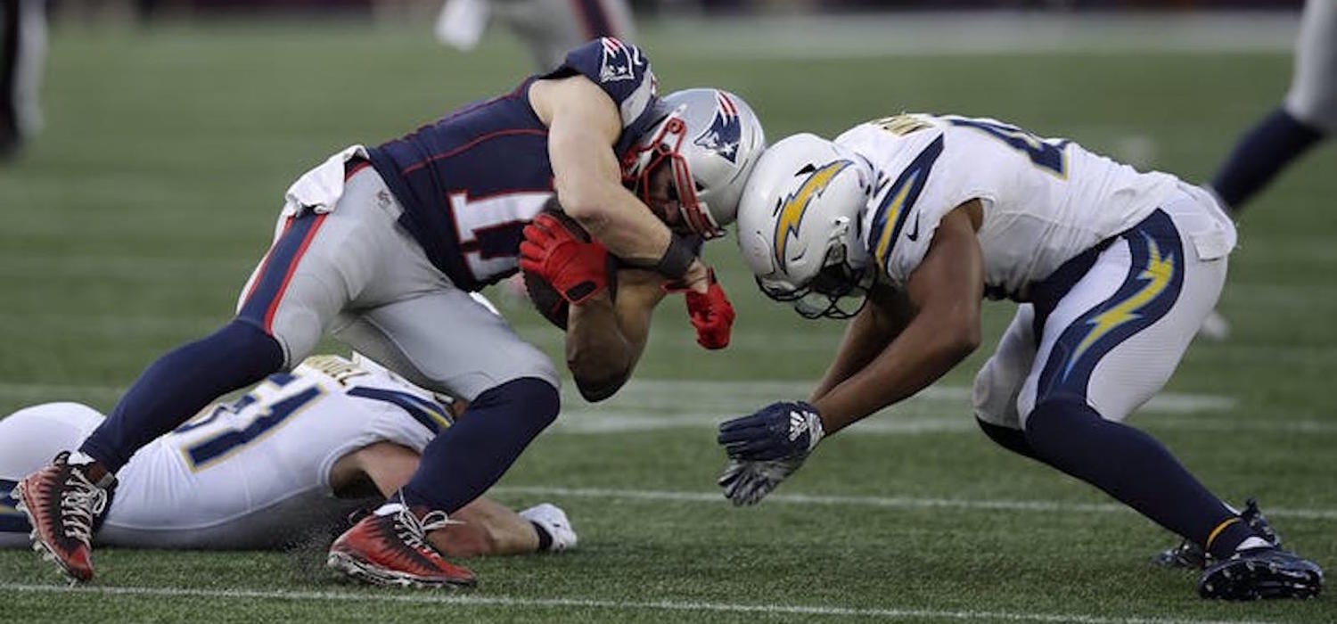 New England Patriots wide receiver Julian Edelman (11) and Los Angeles Chargers linebacker Uchenna Nwosu (42) collide during an NFL divisional playoff football game, Jan. 13, 2019, in Foxborough, Mass. 