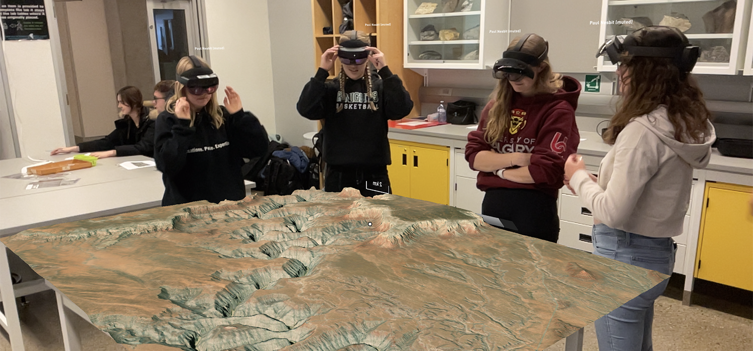 Geoscience students, from left,  Nicole Garner, Emma Hicklin, Kylie Tiedje, and Nichol Gillan use the HoloLens during a geoscience lab (HoloLens image superimposed)