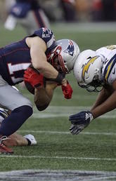 New England Patriots wide receiver Julian Edelman (11) and Los Angeles Chargers linebacker Uchenna Nwosu (42) collide during an NFL divisional playoff football game, Jan. 13, 2019, in Foxborough, Mass. 