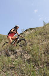 Mountain biker riding the trails in Nose Hill Park, Calgary