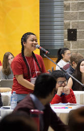 A business student asks a question during the keynote speaker session at a previous conference. 