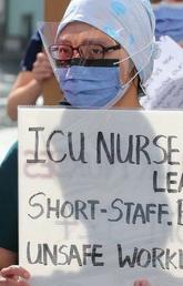 A nurse rallies against wage-suppression legislation in Toronto, Canada on 9 September 2021.