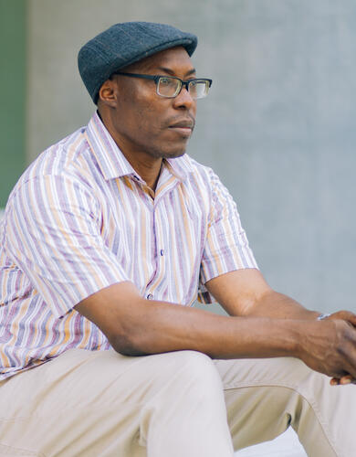 Dr. Uchechukwu Peter Umezurike, sitting, looking into the distance.
