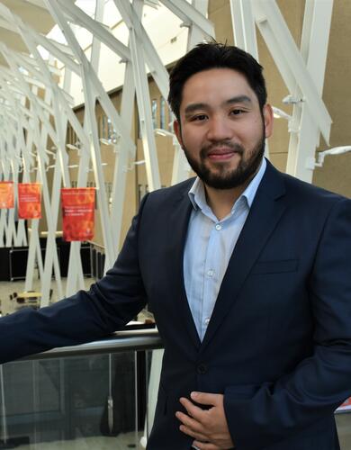 Dr. Michael Chiu, a cardiologist and critical care specialist, poses in the HRIC Atrium at the University of Calgary. 